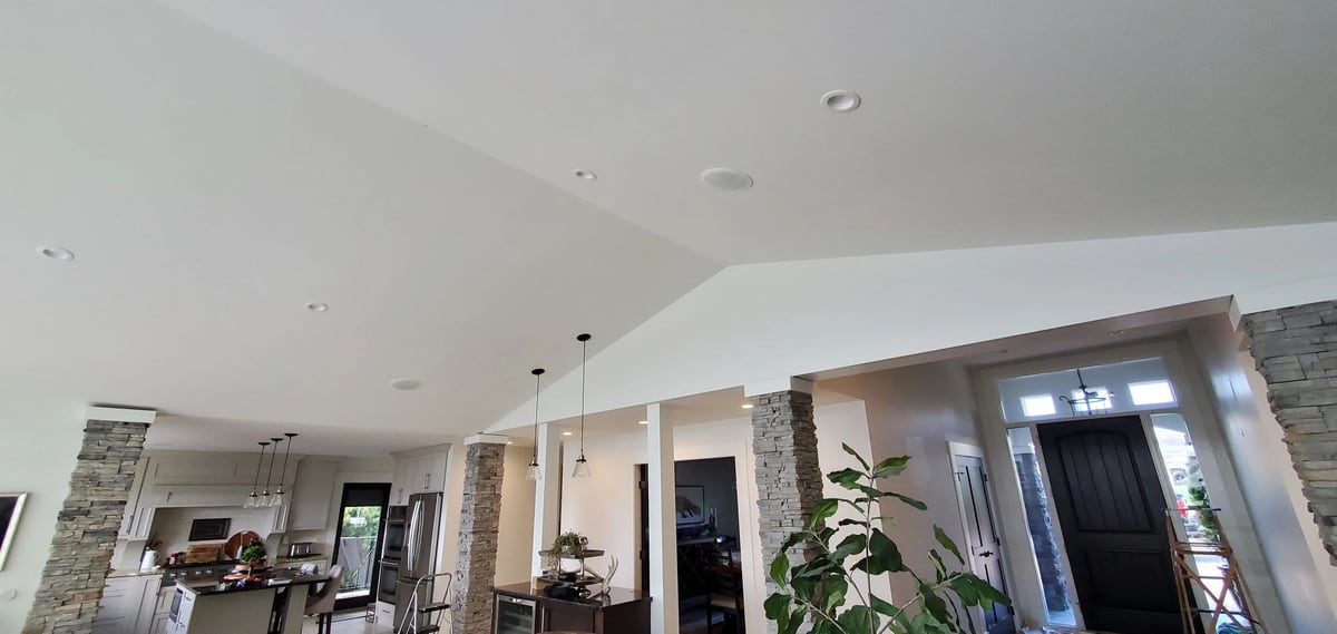 After: Drywall patches around the pot lights, finished into one smooth white vault.